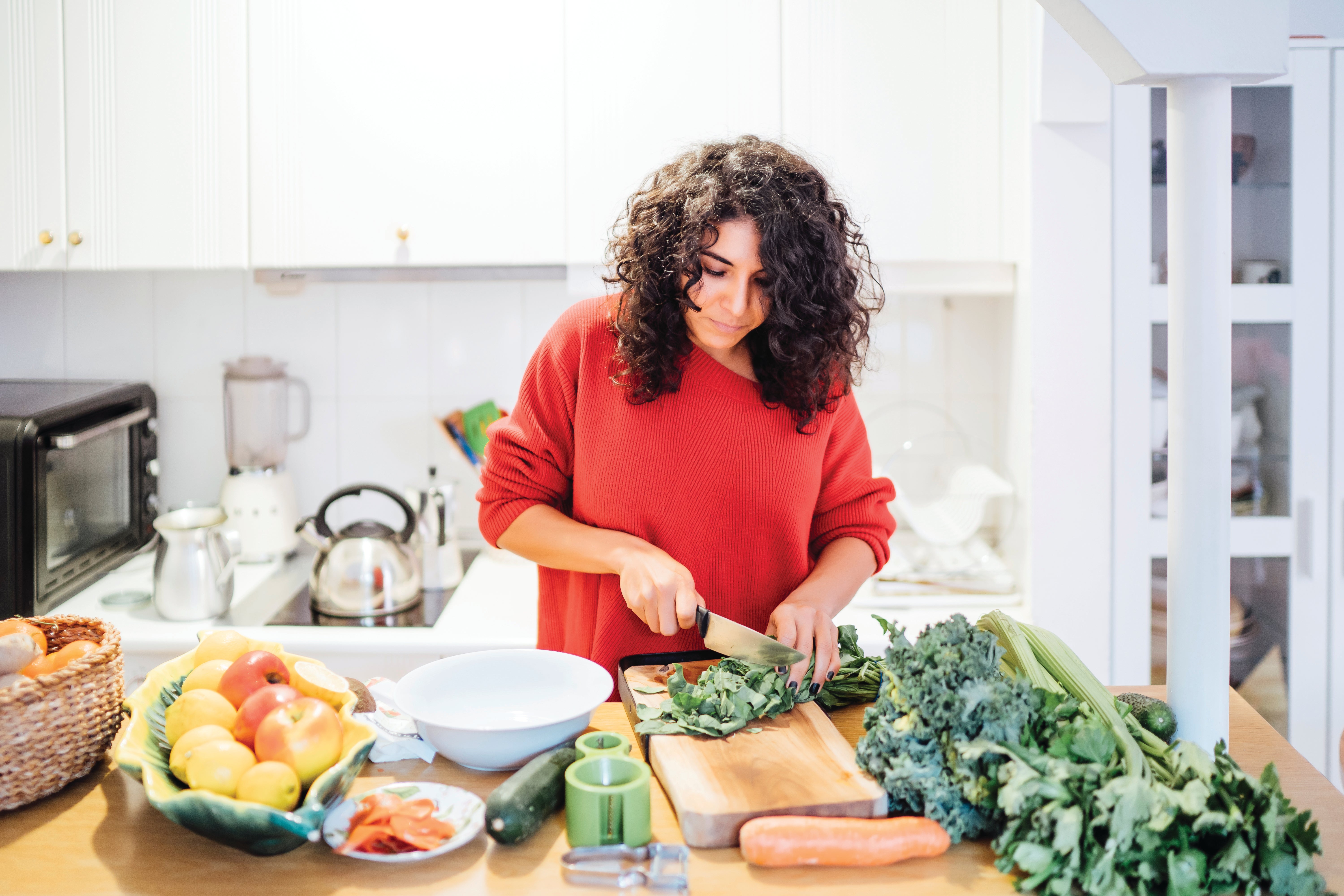 Women cutting vegetables in the kitchen preparing a meal