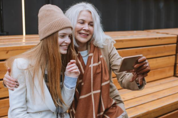 Mother and daughter taking a photo on cellphone