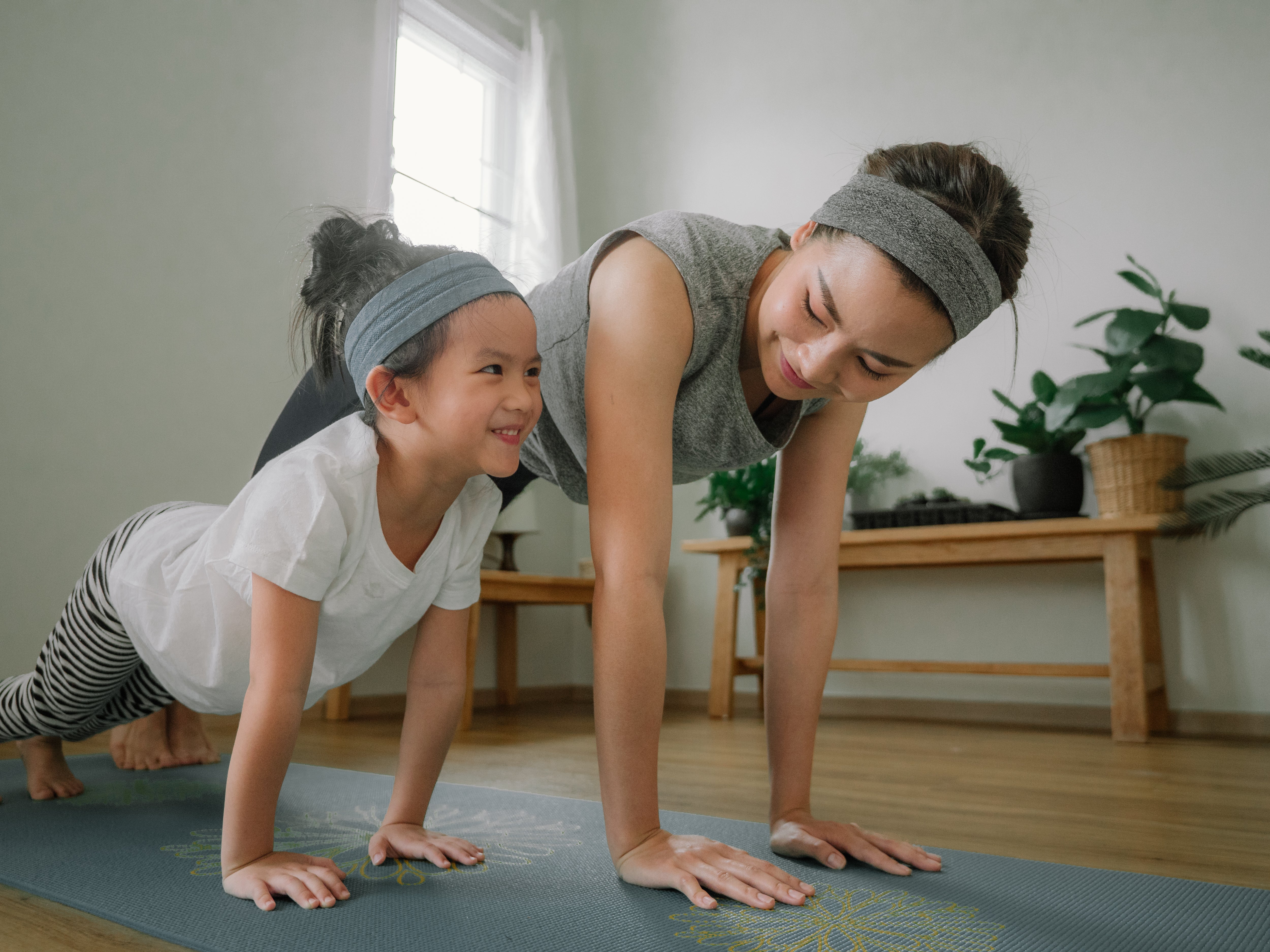 Mom and daughter doing yoga together