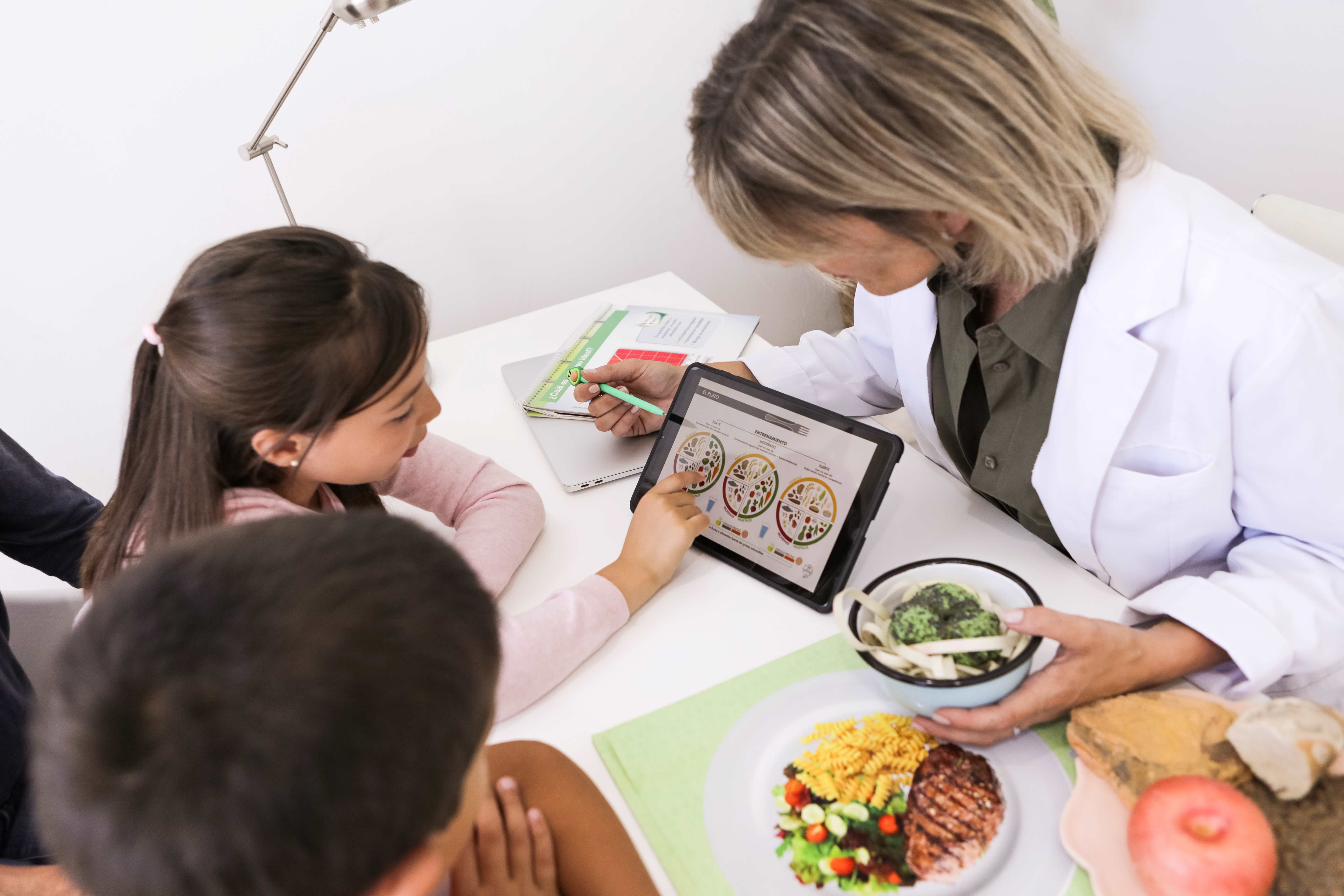 Doctor showing kids healthy food options