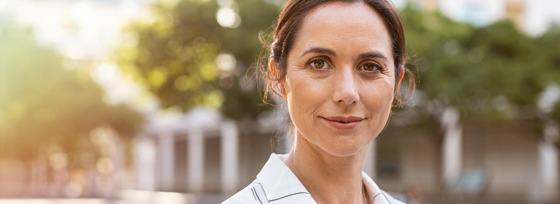 A women smiling outside